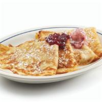 Swedish Crepes · Four delicate crepes topped with sweet-tart lingonberries, butter & powdered sugar.