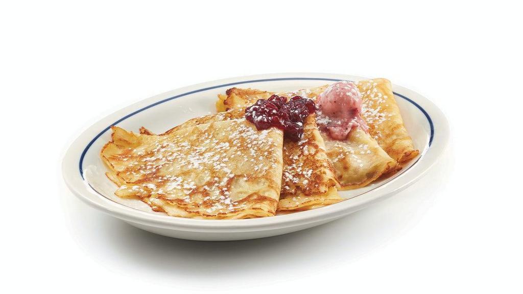 Swedish Crepes · Four delicate crepes topped with sweet-tart lingonberries, butter & powdered sugar.