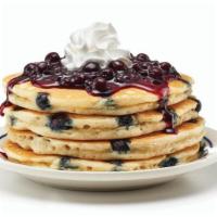 Double Blueberry Pancakes · Double the blueberries, double the taste! Four fluffy buttermilk pancakes filled with bluebe...