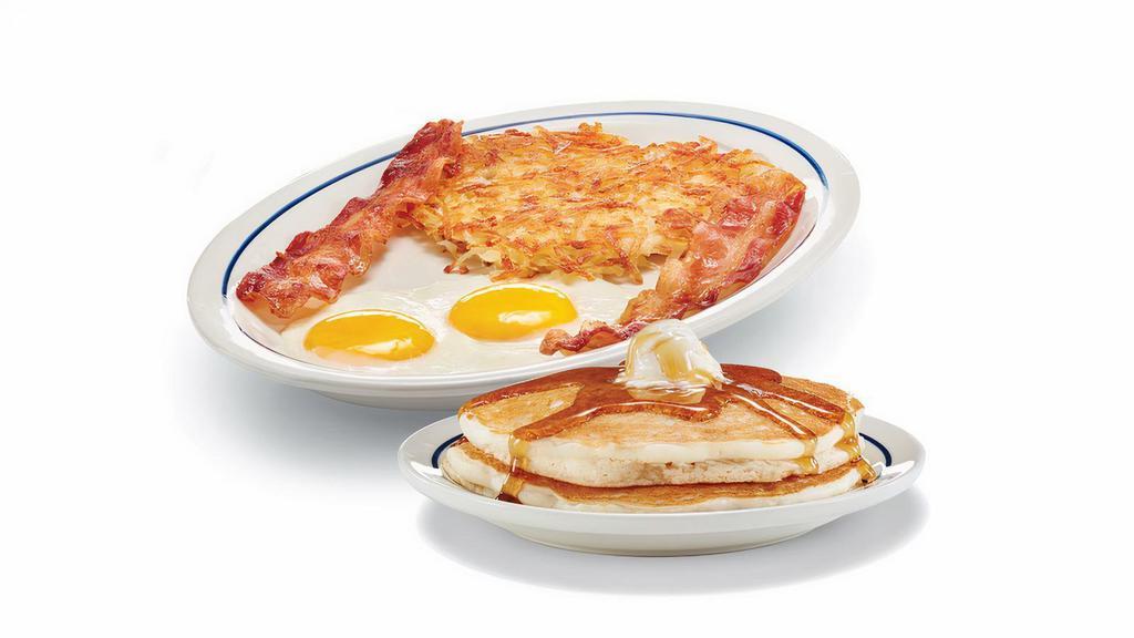 Original Gluten-Friendly Pancake Combo · Two fluffy, gluten-friendly pancakes topped with whipped real butter. Served with 2 eggs* your way, two bacon strips or pork sausage links, and our golden hash browns.