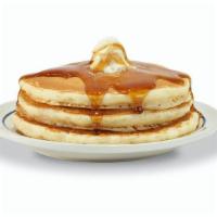 55+ Buttermilk Pancakes · Three fluffy world-famous buttermilk pancakes topped with whipped real butter.