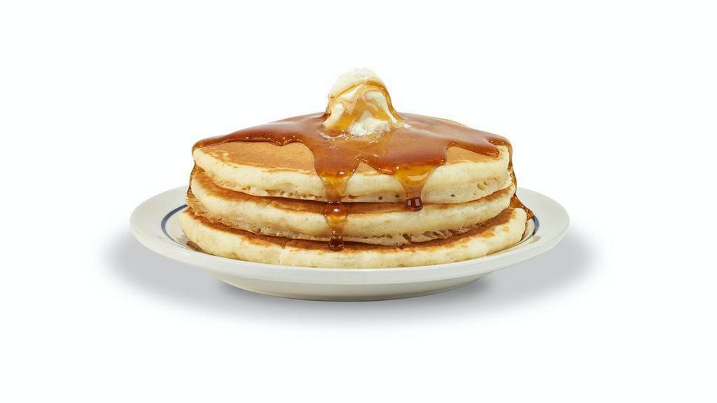 55+ Buttermilk Pancakes · Three fluffy world-famous buttermilk pancakes topped with whipped real butter.