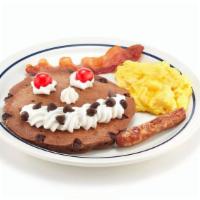 Funny Face® Pancake Combo  · A chocolate chip pancake topped with whipped topping & chocolate chip smile and maraschino c...