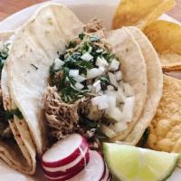 Carnitas (2) · Slow roasted, locally sourced pork shoulder, corn tortillas, cilantro, onions, and lime.
