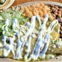 Enchiladas Mineras (2) · Corn tortillas filled with potato, carrot, zucchini in red sauce. Crema and queso fresco. Ch...