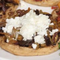 Sopes · Two thick corn masa medallions, topped with lettuce, refried beans, queso fresco and crema.