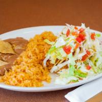 Taco Salad · Flour Shell, rice, Whole beans, (choice of meat) lettuce, guacamole, cheese, sour cream, and...