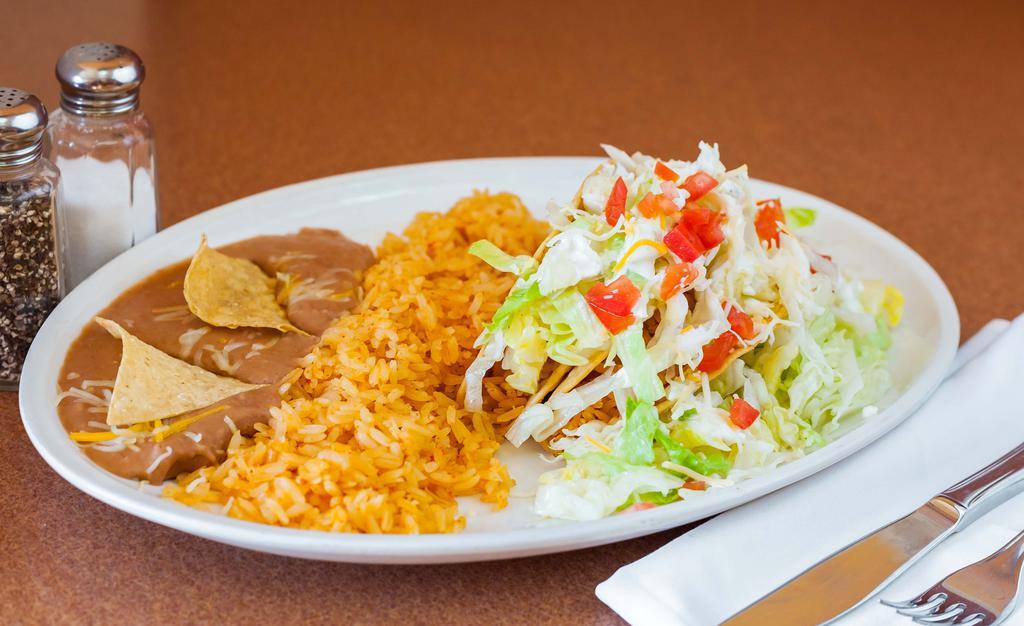 Taco Salad · Flour Shell, rice, Whole beans, (choice of meat) lettuce, guacamole, cheese, sour cream, and pico de gallo.