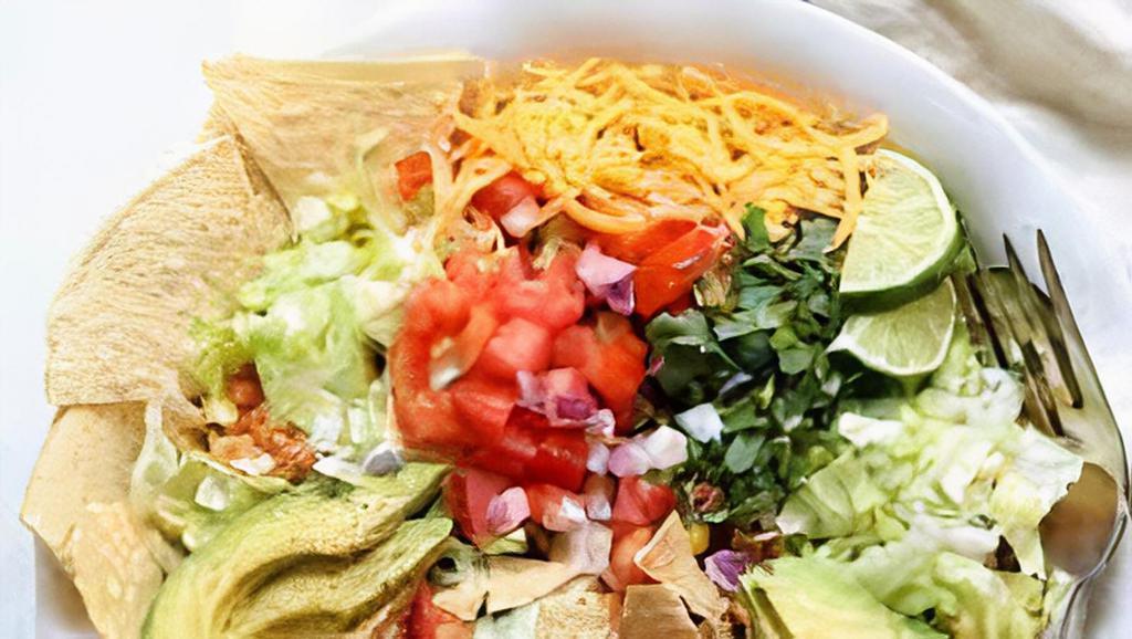 Veggie Taco Salad · Four shell, rice, whole beans, guacamole, cheese, sour cream, and pico de gallo.