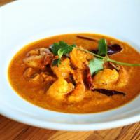 Kerala Style Coconut Shrimp Curry · Sautéed shrimp, creamy coconut sauce, curry leaves, mustard seeds.