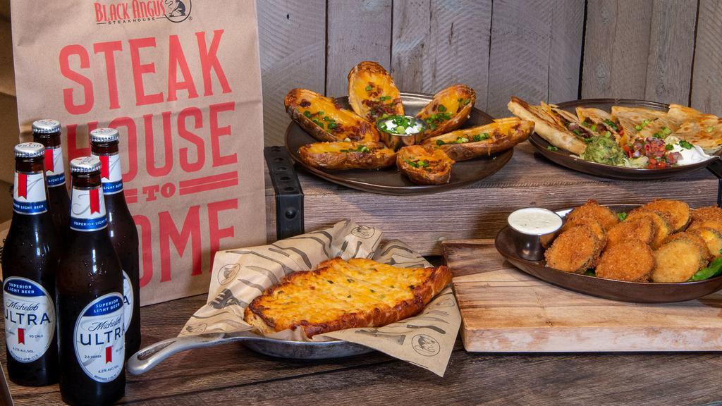 Happy Hour To Go Pack · Loaded Potato Skins, Three Cheese Garlic Bread, Crispy Fried Garlic-Pepper Zucchini, a Steak Quesadilla, and your choice of house wine, 4-pack of beer or 4 non-alcoholic beverages.