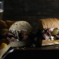 New York Steak Sandwich · Hand-cut, flame-grilled, sliced New York strip with sautéed onions, mayo, and bleu cheese cr...