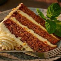 Spiced Carrot Cake · Slice of carrot cake, with pineapple and walnuts, a dash of vanilla and cinnamon, layered to...