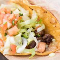 Steak Taco · Chef-griddled stone ground corn tortilla, Monterey cheese, grilled onions, lettuce, pico, pa...