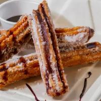Caramel Churros · Served with cinnamon sugar and topped with dark chocolate.