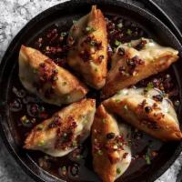 Handmade Pork Dumplings | 6 Count · Pan-fried or steamed, light chili sauce drizzle