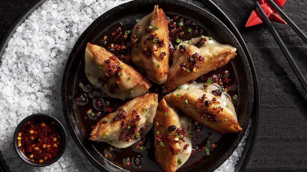 Handmade Pork Dumplings | 6 Count · Pan-fried or steamed, light chili sauce drizzle