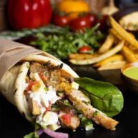 Chicken Shawarma Wrap · Fire roasted chicken served in warm pita bread with homemade hummus, chopped salad, pickled ...