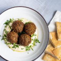 Hummus with Falafel (4 pcs) · Served with one pita and fresh jalapeno sauce.