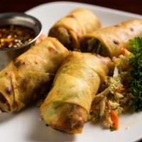 Filet Mignon Spring Rolls · Hand-rolled with seasoned ground filet mignon and Asian slaw. Soy sesame ginger dipping sauc...