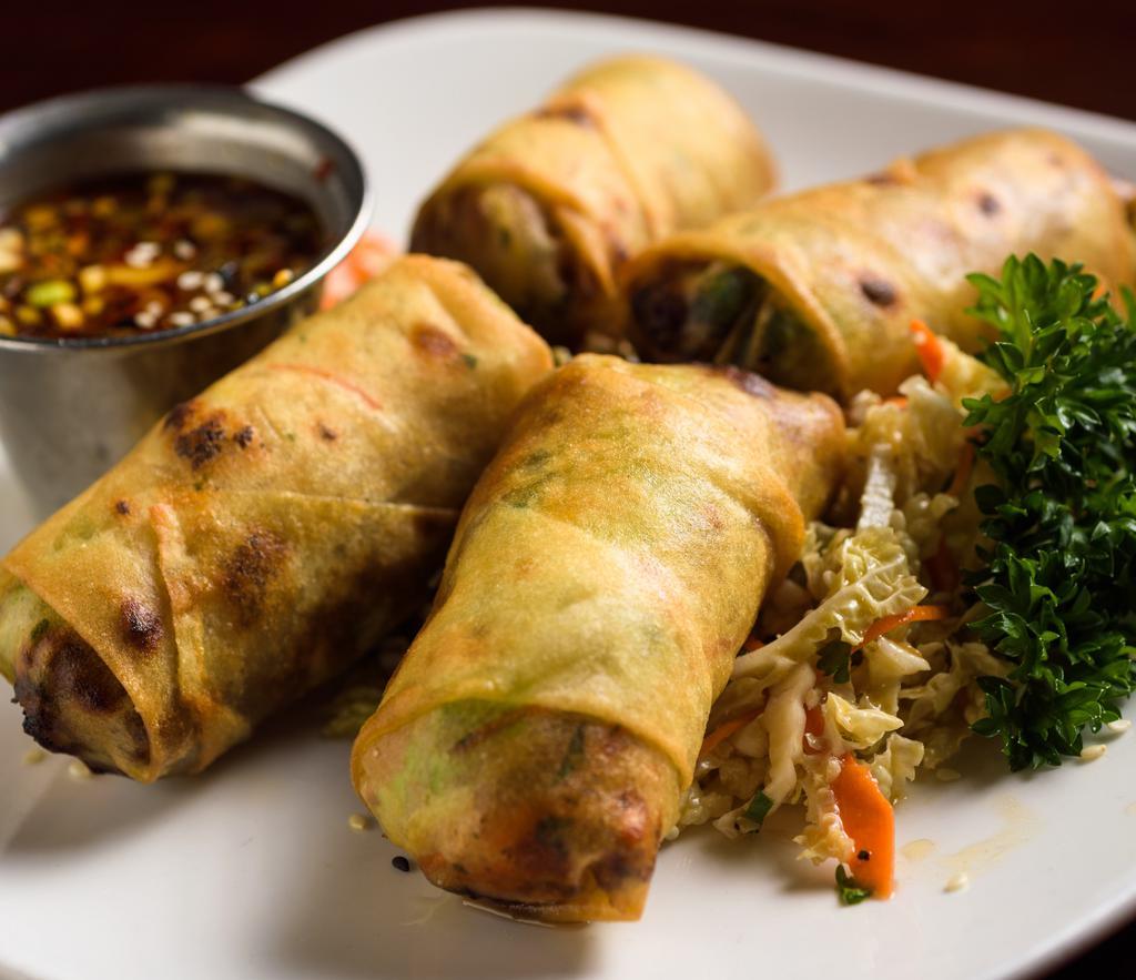 Filet Mignon Spring Rolls · Hand-rolled with seasoned ground filet mignon and Asian slaw. Soy sesame ginger dipping sauce on the side.