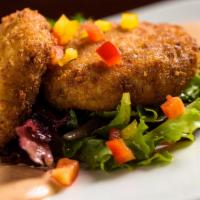 Dungeness Crab Cakes · Two crab cakes lightly fried golden brown. Served with seasoned organic greens & a sherry ca...