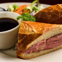 Our Famous French Dip · Slow roasted prime rib sliced deli thin & piled high.  Served on a toasted sourdough roll wi...