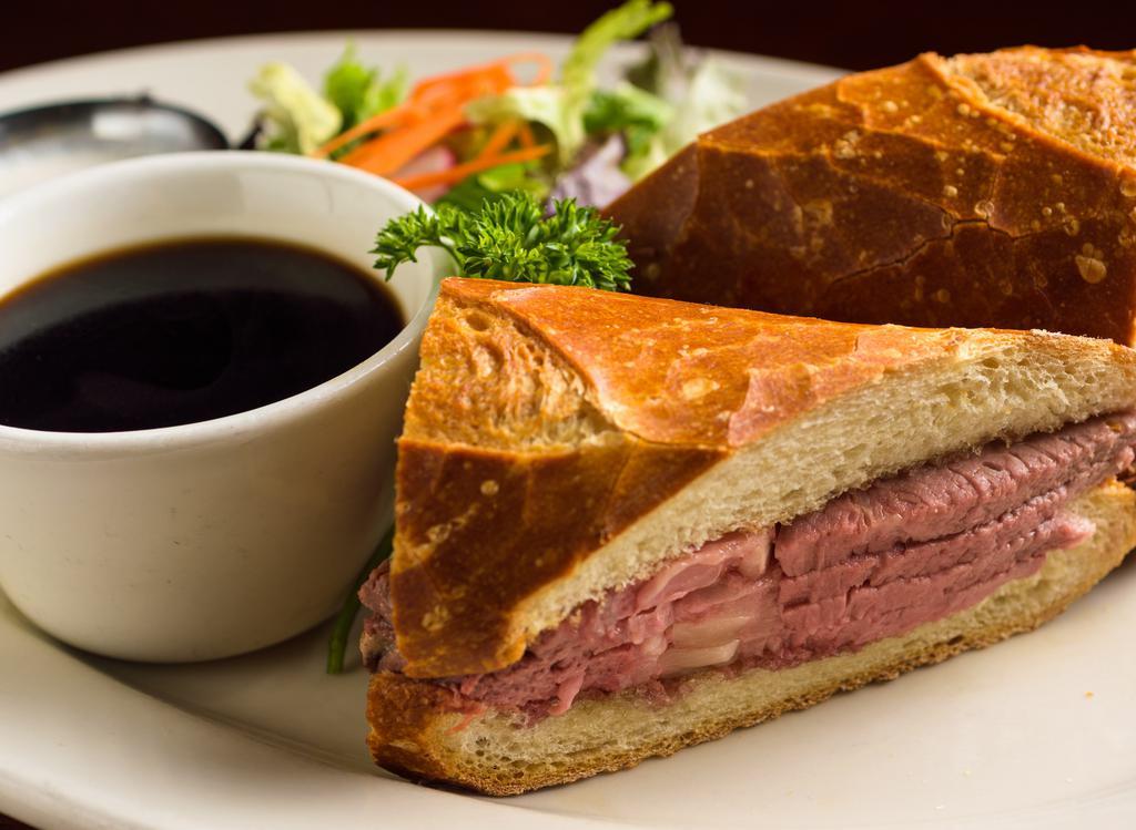Our Famous French Dip · Slow roasted prime rib sliced deli thin & piled high.  Served on a toasted sourdough roll with hot au jus 