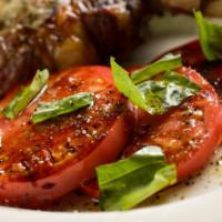 Balsamic Tomatoes · Sliced organic beefsteak tomatoes, red onion & slivered basil.  Reduced balsamic vinegar & e...