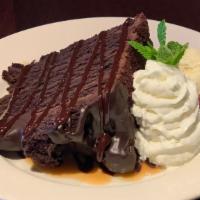 Six Layer Chocolate Cake · Rich dark chocolate cake with fudge frosting and chocolate shavings. Served with Ghirardelli...