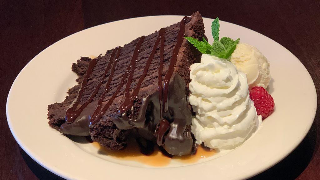 Six Layer Chocolate Cake · Rich dark chocolate cake with fudge frosting and chocolate shavings. Served with Ghirardelli chocolate & caramel sauce on the side.