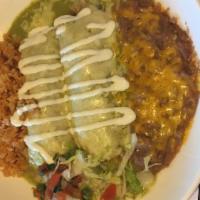 Enchiladas Suizas · Two corn tortillas filled with chicken, green onions, roasted mushrooms, green tomatillo sau...