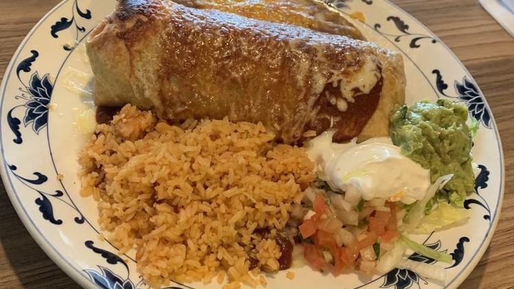 Chimichanga · Deep-fried burrito topped with red chile sauce and cheese. Served with rice, beans, guacamole, sour cream and salsa fresca.