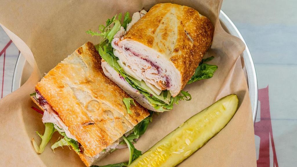 #15 Cranberry Turkey · Thinly sliced Turkey topped with our Cranberry Sauce, with your choice of produce, Dijon and Swiss Cheese, served on our freshly baked Sourdough bread, built the way you like it!