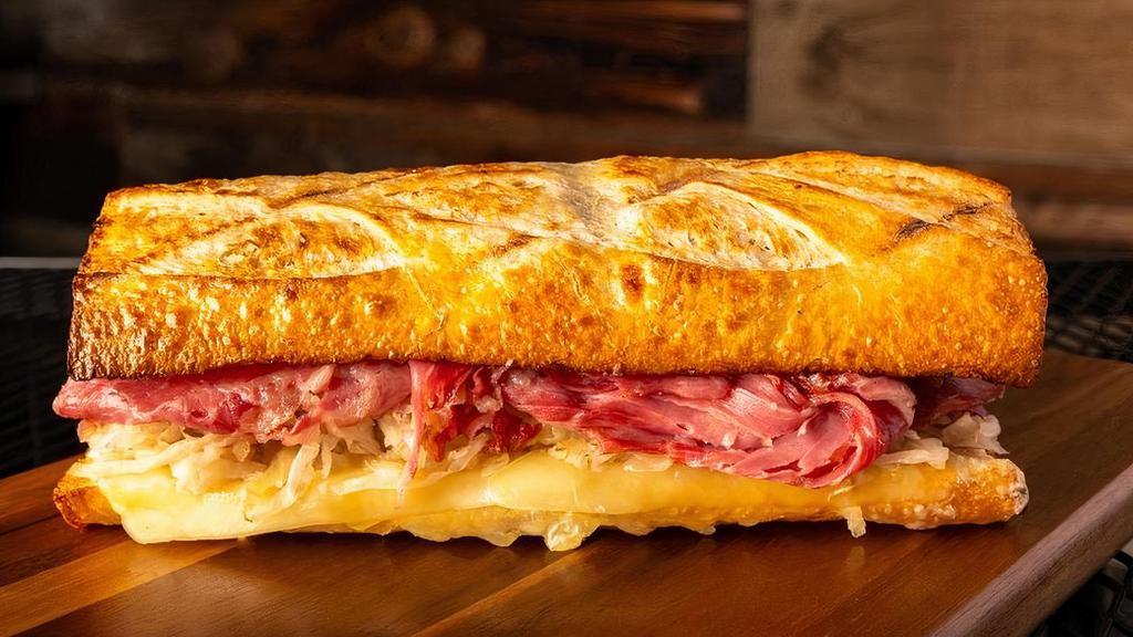 #7 Reuben · Thinly sliced Corned Beef, with our House Sauce, Sauerkraut and Swiss Cheese served toasted on our freshly baked Sourdough bread. Please note we typically serve this sandwich hot & toasted!
