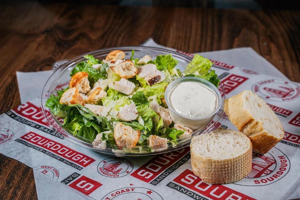 Grilled Chicken Caesar Salad · Chopped Romaine topped with Shaved Parmesan, Grilled Chicken, house-made Sourdough Croutons & with a side of Caesar Dressing
