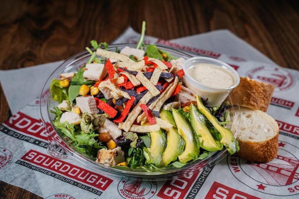 Southwest Chicken Salad · Spring Mix and Chopped Romaine, with Grilled Chicken, Sliced Avocado, Black Bean Corn Salsa, Tortilla Strips, Pepper Jack Cheese & a side of Jalapeno Ranch Dressing