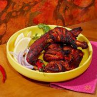 Tandoori Chicken · Spicy chicken with yogurt, ginger, garlic, and spices and char grilled in the tandoor grill.
