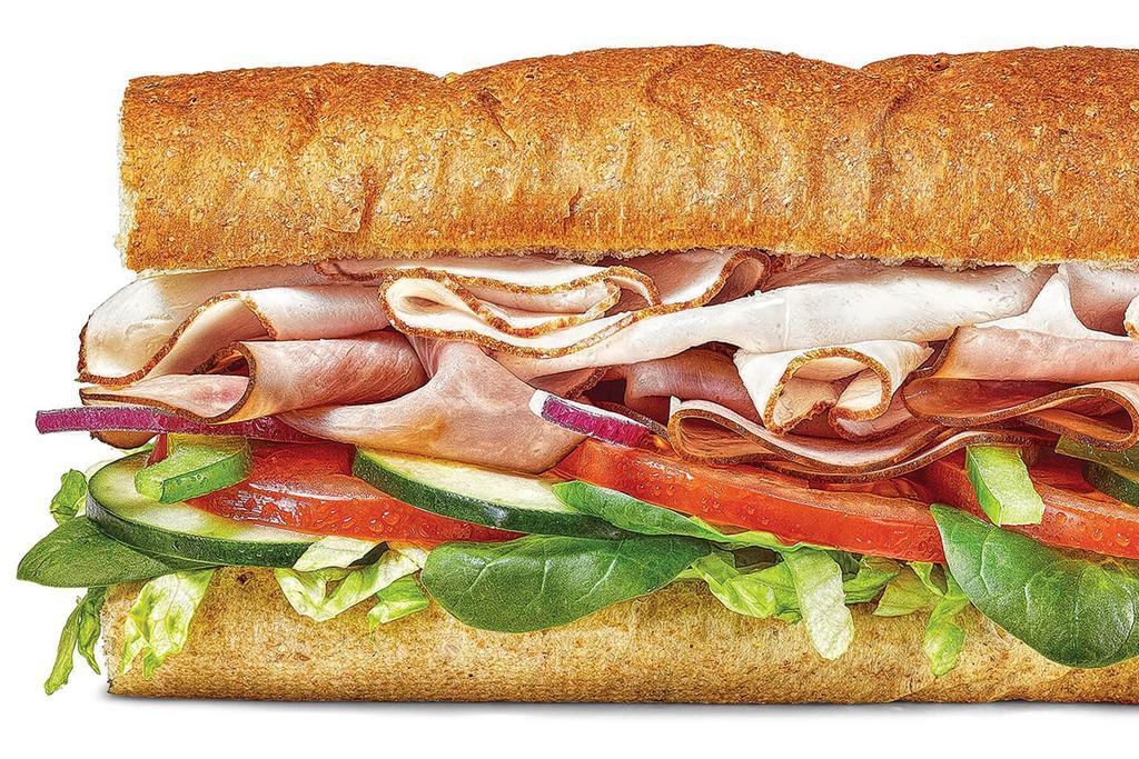 Oven Roasted Turkey & Ham · Enjoy the flavor of tender, thin-sliced oven roasted turkey and Black Forest Ham with your favorite veggies, from juicy tomatoes to sweet red onions, all served on freshly baked, Hearty Multigrain bread.