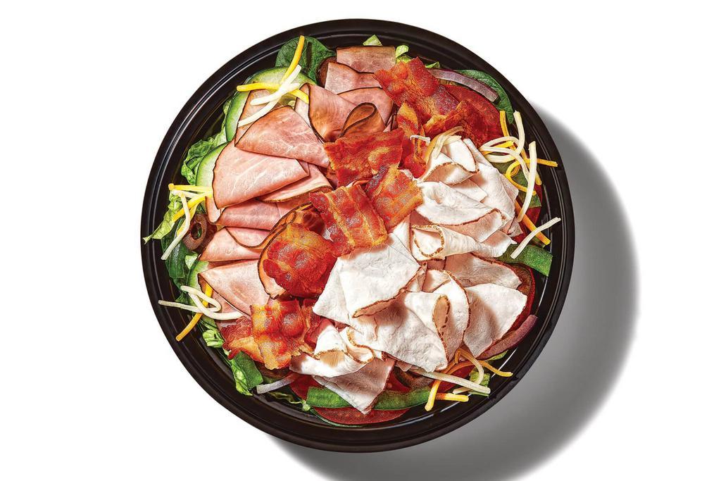 All-American Club® (430 Cals) · Everything you want in the classic All-American Club® sandwich, all in a bowl. Oven roasted turkey, Black Forest ham and hickory smoked bacon pack the protein. With lettuce, baby spinach, tomatoes, cucumber, green peppers, black olives, red onions, and Monterey cheddar cheese.