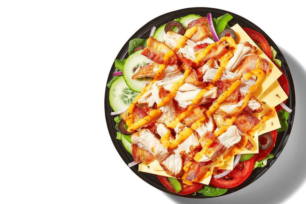 Baja Chicken & Bacon (720 Cals) · Energize your meal with extra helpings of Rotisserie-Style Chicken, Pepper Jack Cheese, and Hickory-Smoked Bacon, piled high on crisp veggies and topped with our Baja Chipotle sauce.