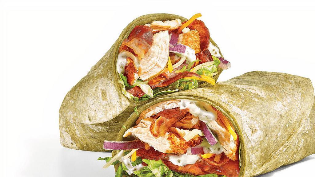 Chicken & Bacon Ranch (840 Cals) · This crave-worthy wrap has it all: hand-pulled, Rotisserie-Style Chicken, smothered in shredded Monterrey Cheddar Cheese, Hickory-Smoked Bacon, and Peppercorn Ranch, folded in a Spinach wrap.