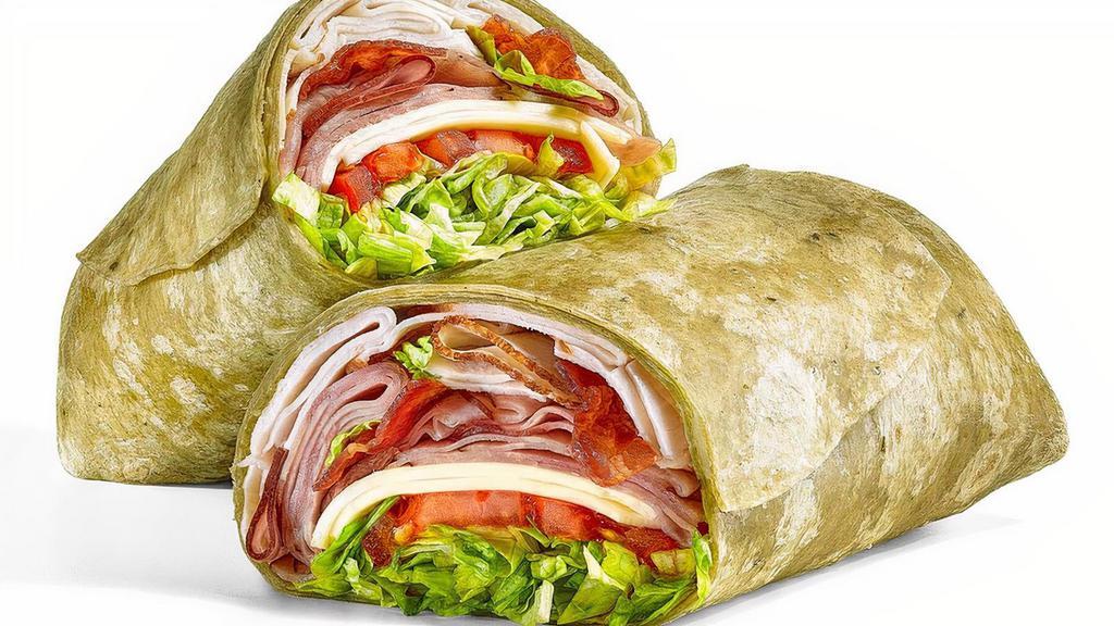 All-American Club® (630 Cals) · The All-American Club® wrap is a delicious combo of oven roasted turkey, Black Forest ham and hickory smoked bacon. We top it off with American cheese, lettuce, tomatoes and red onions, served up in a delicious spinach wrap.