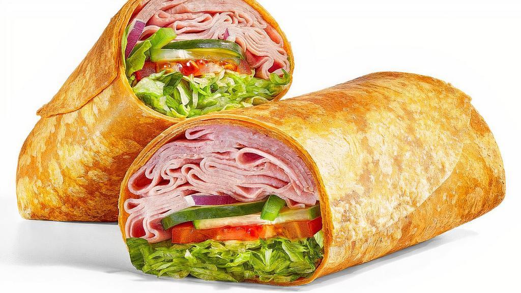Cold Cut Combo® (530 Cals) · Can’t decide what kind of meat you want? Get three at once on a delicious tomato basil wrap. Stacked with a double portion of turkey-based meats including ham, salami, and bologna. Enjoy it with lettuce, tomatoes, cucumbers, green peppers, and red onions.