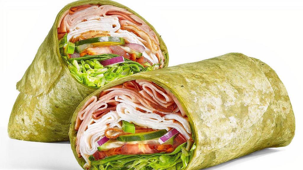 Oven Roasted Turkey & Ham (430 Cals) · Take a bite of this Spinach wrap filled with a footlong portion of our tender, thin-sliced oven roasted turkey and tasty Black Forest ham. Top it with lettuce, spinach, tomatoes, cucumbers, green peppers and red onions. It’s simply delicious.