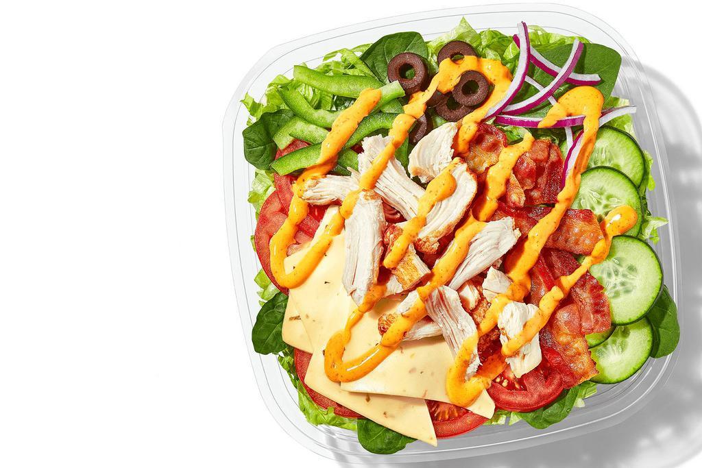 Baja Chicken & Bacon (460 Cals) · When your salad game could use some zest: Rotisserie-Style Chicken, Pepper Jack Cheese, and Hickory-Smoked Bacon in a big bowl of veggies and topped with our Baja Chipotle sauce.