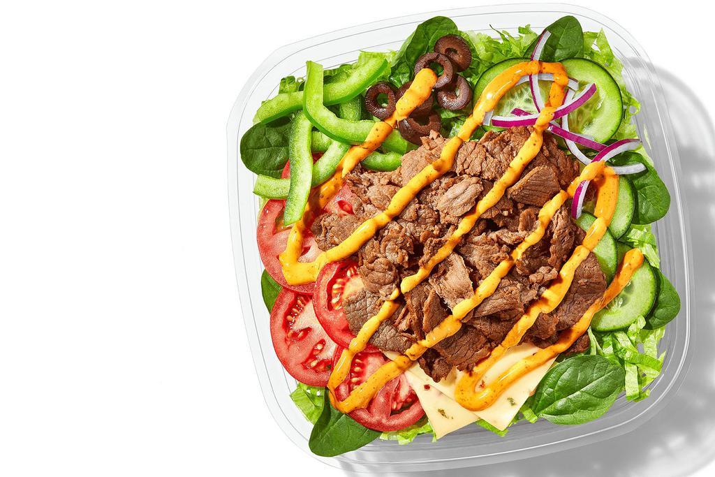  Baja Steak & Jack (350 Cals) · This is no “side salad”: it’s the main course. Steak and Pepper Jack Cheese are piled on fresh, crisp veggies and drizzled with Baja Chipotle Sauce for a whole bowl of awesomeness.