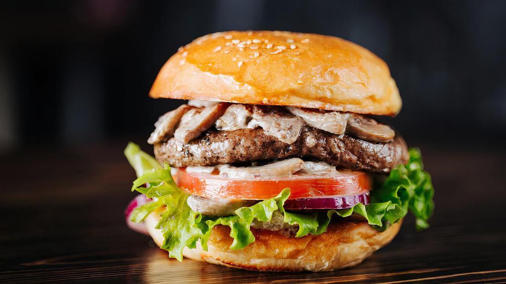 The Classic Mushrooms Burger · Grilled black Angus patty, mushrooms, salt and pepper, onions, tomatoes.