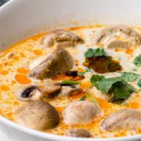 #15 Tom Kha · Spicy coconut milk soup with chicken or prawns, lemongrass, galangal, mushroom, lemon juice,...