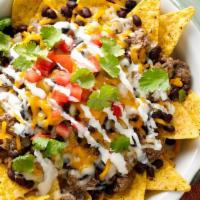 SUPER NACHOS JAVIS  · crispy tortilla chips topped with black beans, pinto beans, Oaxaca/jack cheese, chicken and ...